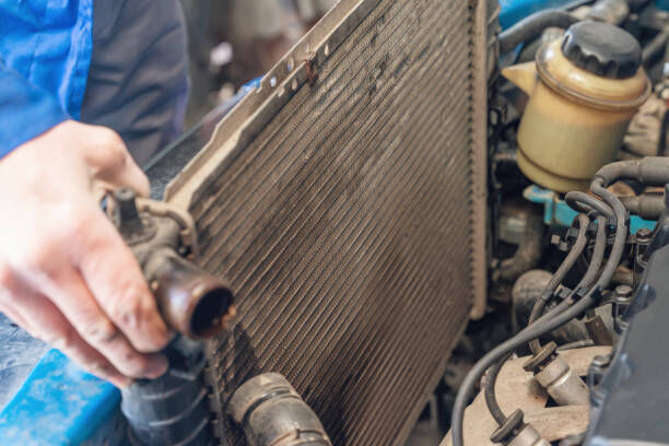 Image of a professional coolant flushing machine connected to an engine.